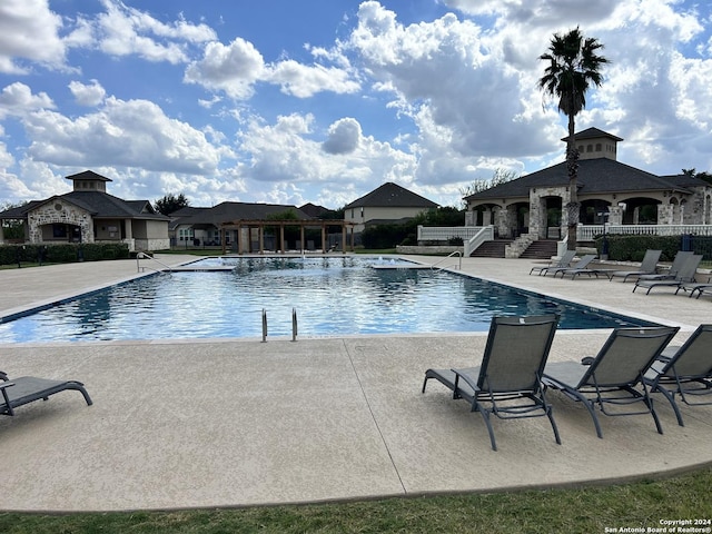 pool featuring a gazebo, fence, and a patio area