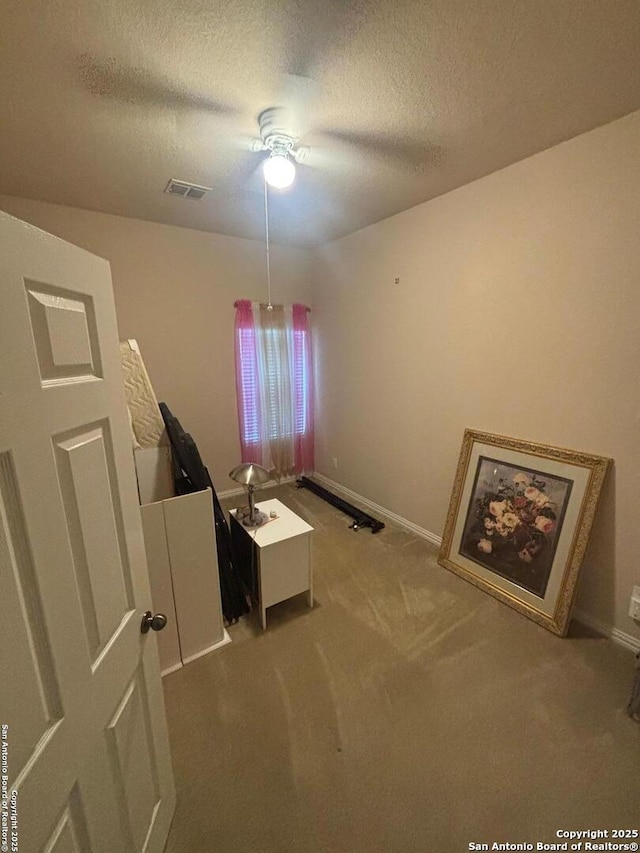 12606 Ozona, San Antonio, TX 78245 - unfurnished bedroom featuring visible vents, a textured ceiling, carpet floors, and baseboards