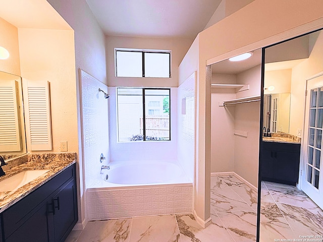 bathroom featuring a sink, two vanities, and marble finish floor