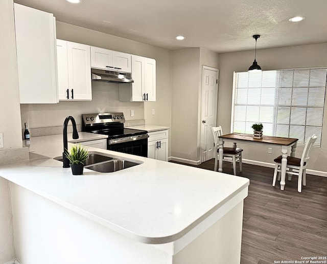 kitchen featuring a sink, stainless steel range with electric stovetop, light countertops, recessed lighting, and under cabinet range hood
