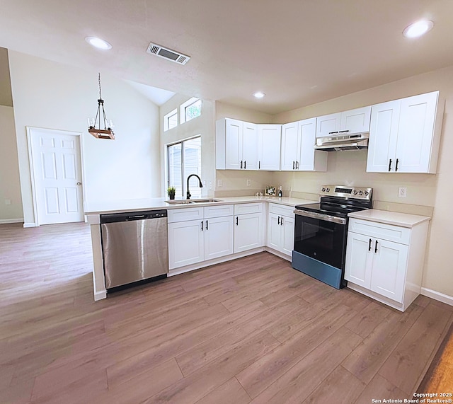 kitchen featuring light wood-style floors, white cabinetry, under cabinet range hood, a sink, and appliances with stainless steel finishes