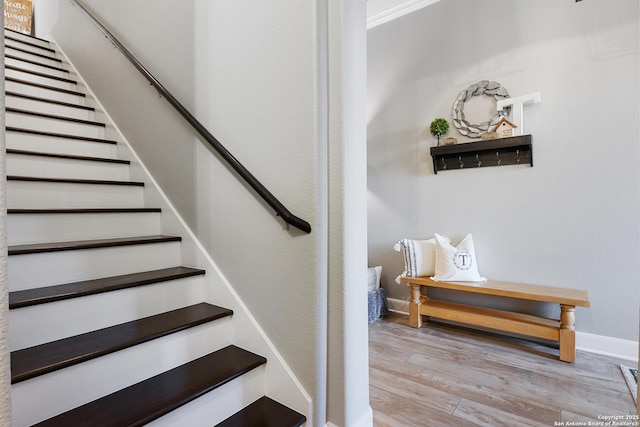 stairway with baseboards and wood finished floors