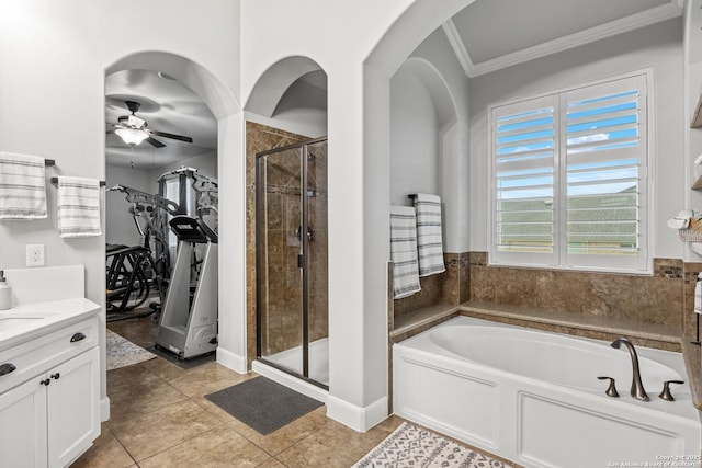 bathroom featuring crown molding, a garden tub, vanity, ceiling fan, and a stall shower