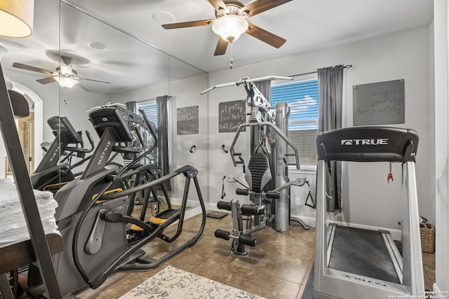 workout room featuring baseboards and a ceiling fan