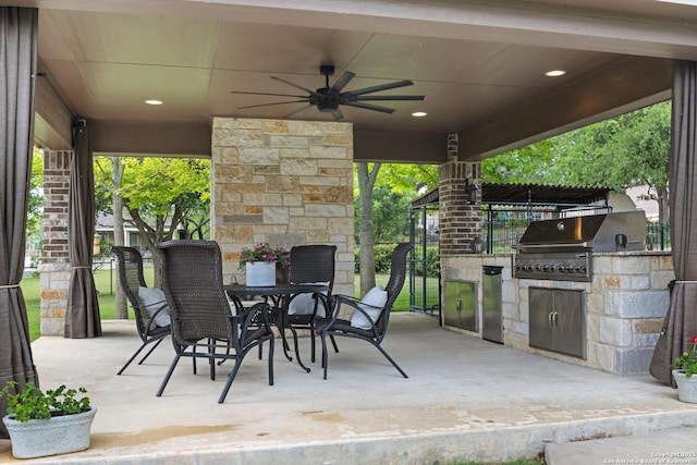 view of patio / terrace featuring a ceiling fan, exterior kitchen, grilling area, and outdoor dining space