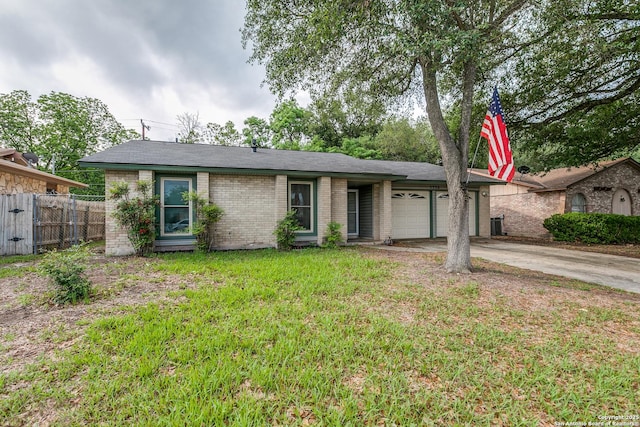 ranch-style home featuring fence, a front lawn, brick siding, a garage, and driveway