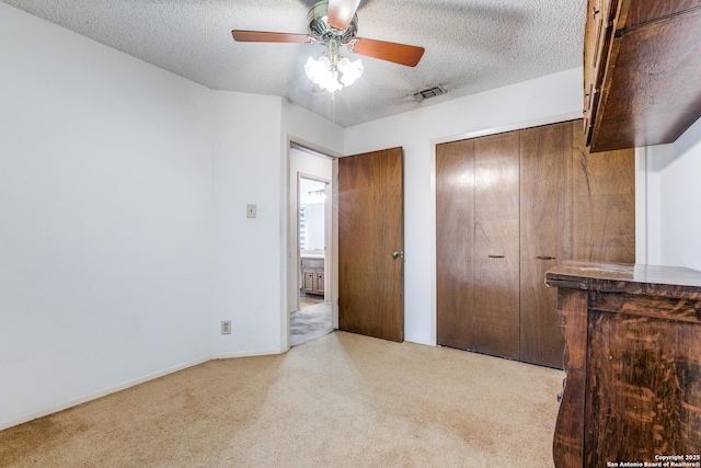bedroom with visible vents, carpet, a textured ceiling, and ceiling fan