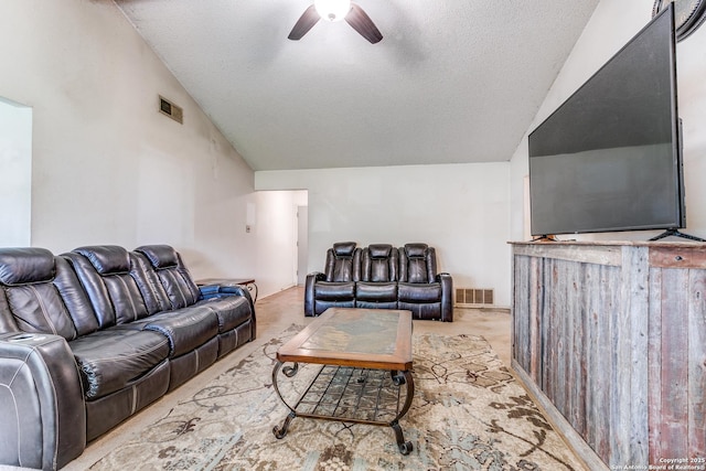 living room featuring visible vents, a textured ceiling, ceiling fan, and lofted ceiling
