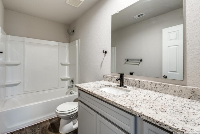 full bath with toilet, visible vents, wood finished floors, and vanity