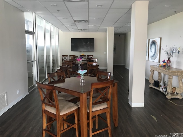7039 San Pedro Unit 810, San Antonio, TX 78216 - dining room with baseboards, visible vents, a drop ceiling, and wood finished floors