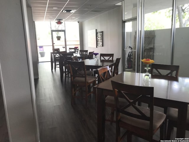 7039 San Pedro Unit 810, San Antonio, TX 78216 - dining area with a drop ceiling, dark wood-style floors, expansive windows, and visible vents