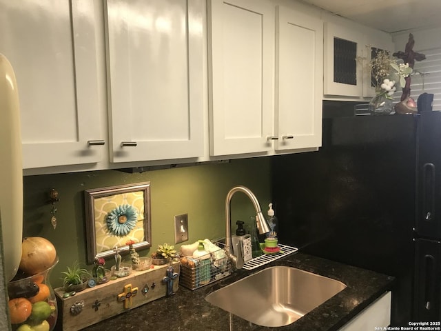 7039 San Pedro Unit 810, San Antonio, TX 78216 - kitchen with a sink, dark stone counters, and white cabinetry