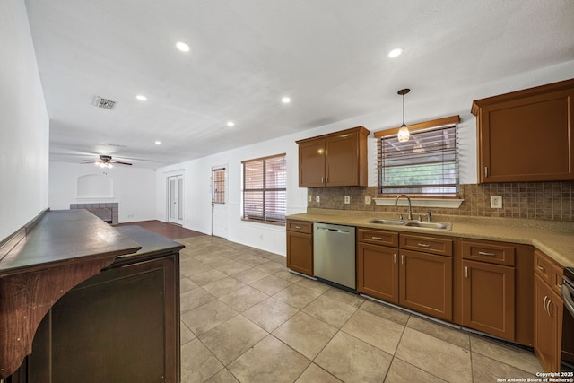 kitchen with ceiling fan, decorative backsplash, a sink, and dishwasher