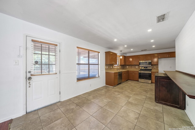 kitchen featuring appliances with stainless steel finishes, recessed lighting, light tile patterned floors, backsplash, and visible vents