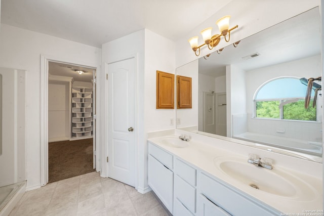 full bathroom featuring visible vents, a sink, tile patterned floors, and a stall shower
