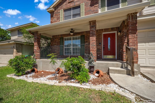 property entrance with an attached garage, a porch, ceiling fan, and brick siding