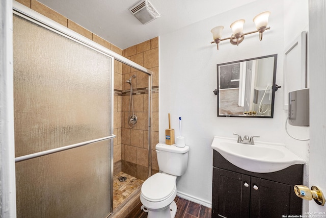 bathroom featuring a stall shower, toilet, wood finished floors, and visible vents