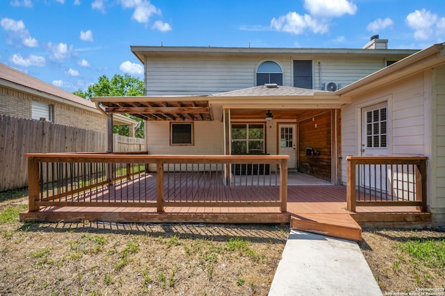 wooden deck with ceiling fan and fence