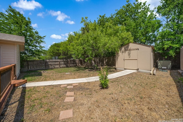 view of yard featuring an outdoor structure, a shed, and a fenced backyard