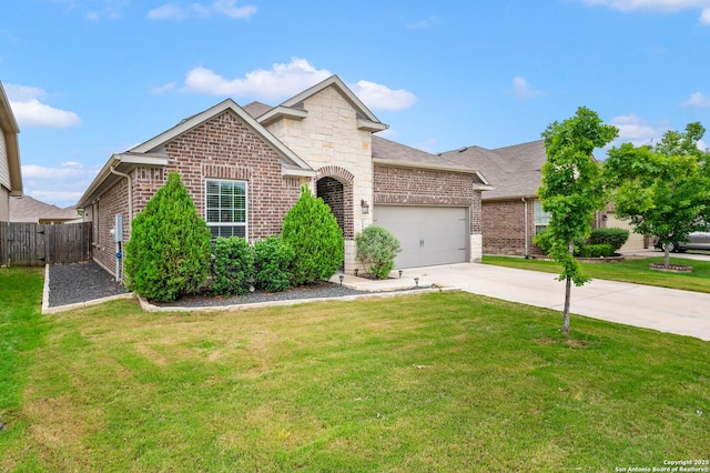 view of front of house featuring a garage, fence, a front yard, brick siding, and concrete driveway