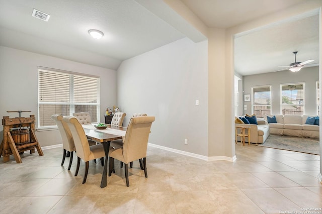 dining space featuring visible vents, baseboards, ceiling fan, and light tile patterned floors