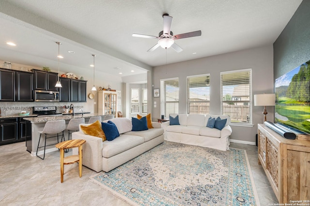 living area with recessed lighting and ceiling fan