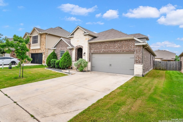 traditional-style home with fence, a front lawn, stone siding, a garage, and concrete driveway