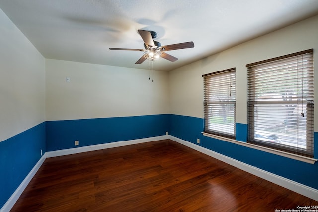 spare room featuring baseboards, a ceiling fan, and wood finished floors
