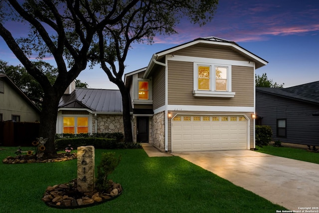 view of front of home with a garage, a front lawn, stone siding, and concrete driveway