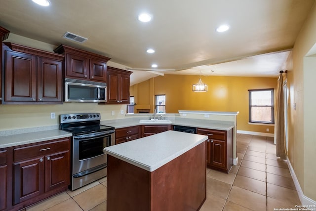 kitchen featuring appliances with stainless steel finishes, a sink, light countertops, a peninsula, and visible vents