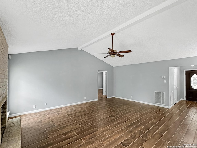 unfurnished living room featuring ceiling fan, dark wood-type flooring, a textured ceiling, and visible vents