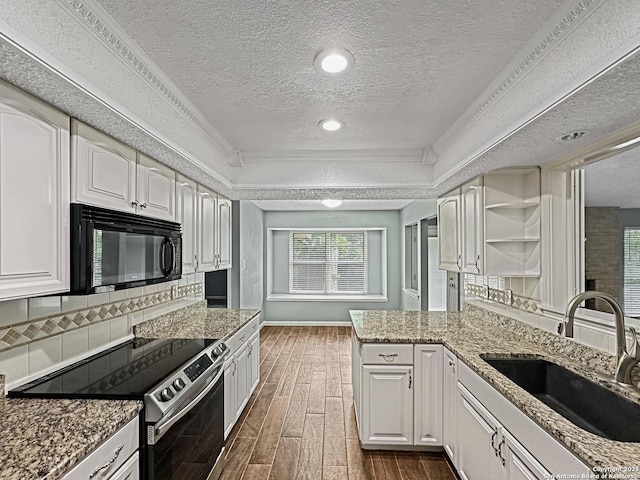 kitchen featuring stainless steel range with electric cooktop, black microwave, a sink, a textured ceiling, and dark wood finished floors