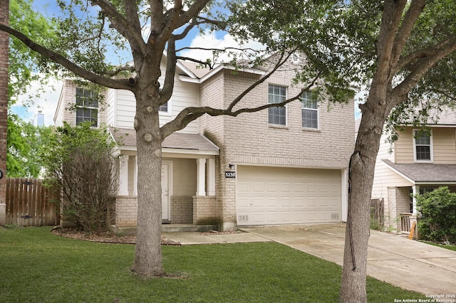 traditional home featuring a front yard, brick siding, fence, concrete driveway, and an attached garage