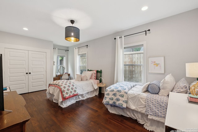 bedroom featuring recessed lighting, a closet, and dark wood finished floors