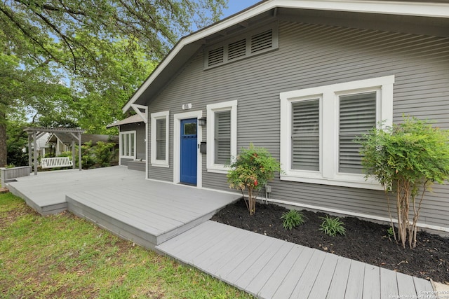 rear view of house with a deck and a pergola