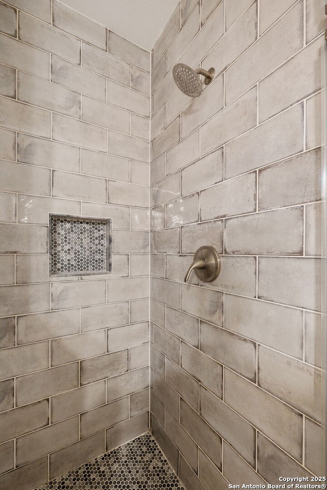full bathroom with tiled shower