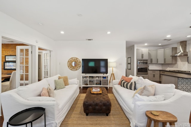 living area featuring french doors, recessed lighting, and visible vents