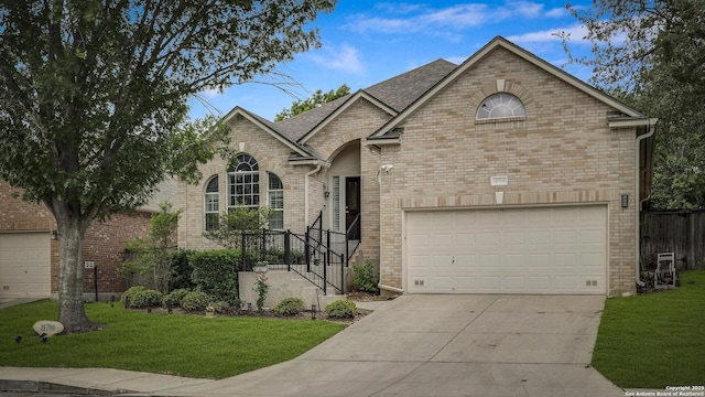 view of front of home with concrete driveway, brick siding, and a front yard