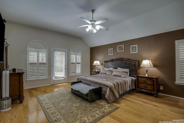 bedroom featuring access to outside, a ceiling fan, wood finished floors, and vaulted ceiling