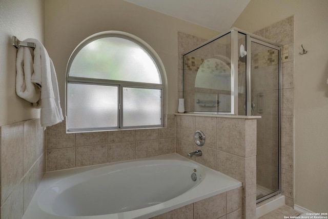 bathroom with a bath and a stall shower