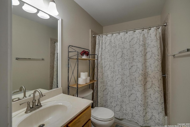 bathroom featuring toilet and vanity