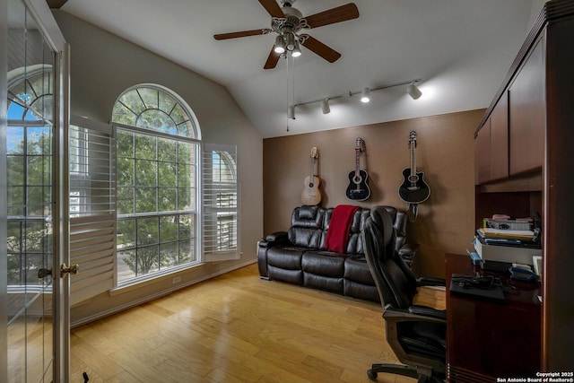 office space featuring ceiling fan, lofted ceiling, track lighting, and light wood finished floors