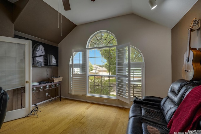 interior space featuring vaulted ceiling, a ceiling fan, and wood finished floors