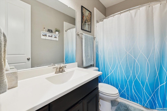 bathroom featuring toilet, curtained shower, and vanity