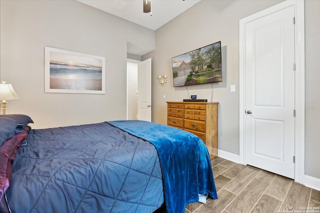 bedroom with a ceiling fan and baseboards