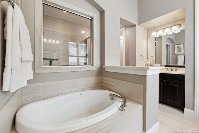 full bath featuring vanity and a bath