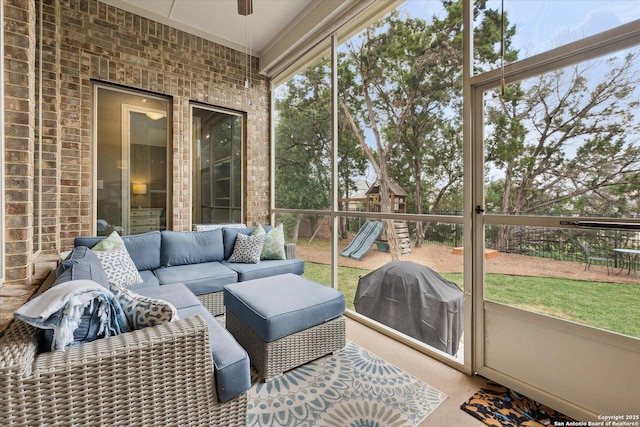 sunroom / solarium featuring ceiling fan and outdoor lounge area