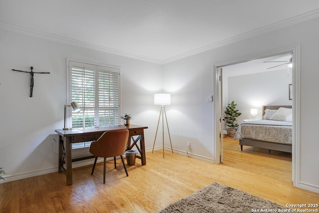 office space with baseboards, ornamental molding, and light wood finished floors