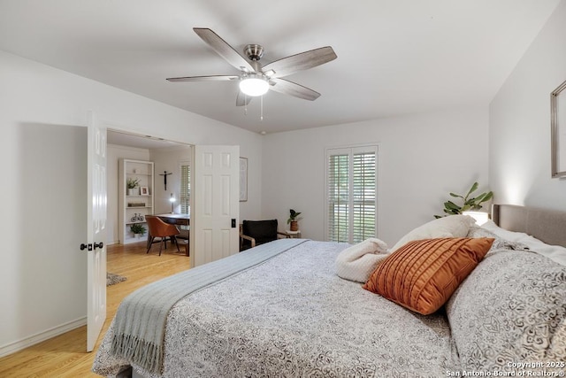 bedroom featuring baseboards, ceiling fan, and light wood finished floors