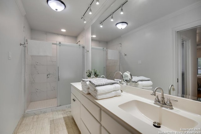 full bathroom featuring a sink, ornamental molding, a shower stall, and double vanity
